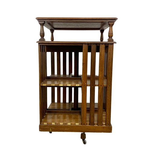 931 - A large Edwardian oak revolving bookcase. 64.5 x 66.5 x 110cm.