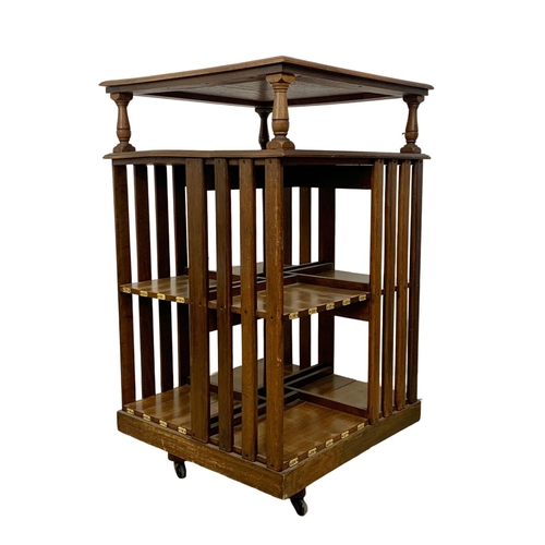 931 - A large Edwardian oak revolving bookcase. 64.5 x 66.5 x 110cm.