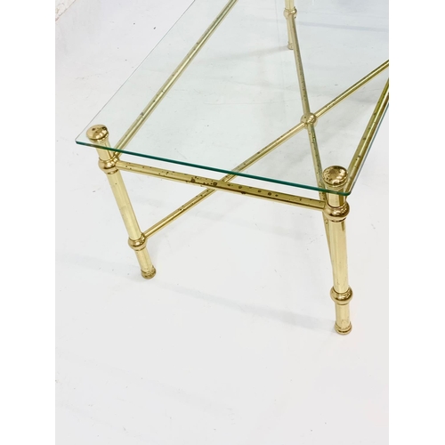 930 - A vintage Italian brass framed coffee table, with glass top. 110.5 x 55.5 x 45.5cm