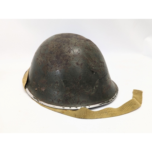 170 - A World War II helmet with gasmask