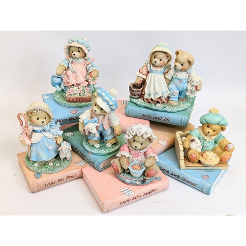 673 - A collection of Cherished Teddies figures with Mary Moo Moo figures.