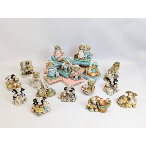 673 - A collection of Cherished Teddies figures with Mary Moo Moo figures.