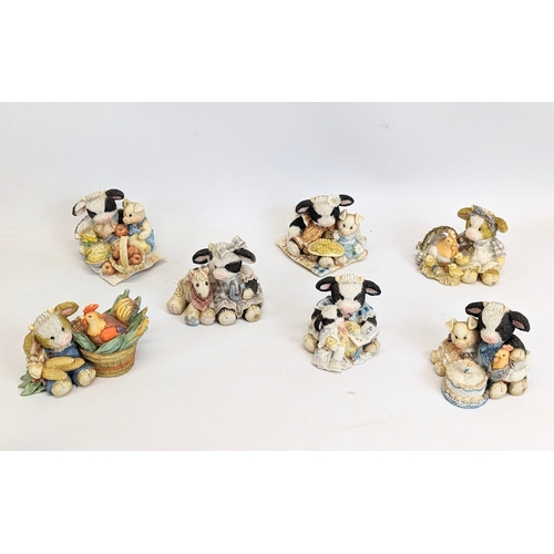 673 - A collection of Cherished Teddies figures with Mary Moo Moo figures.