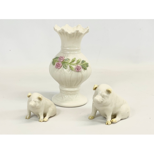 677 - Two 3rd period Belleek Pottery green stamp pigs and a blue stamp vase. Vase measures 16cm