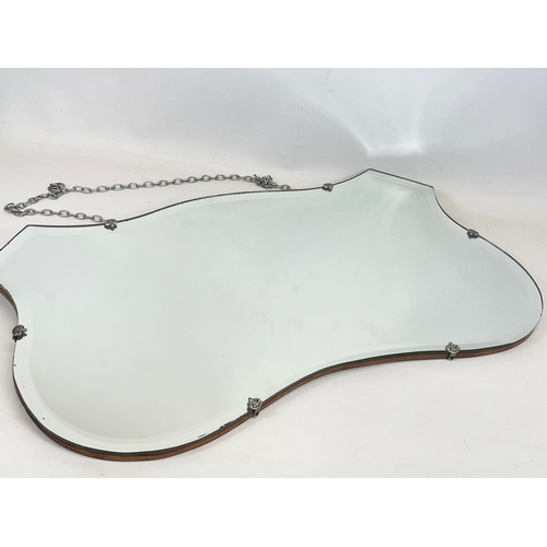 181 - An Art Deco bevelled mirror. 68 x 40cm