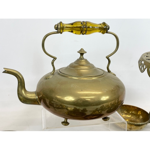 697 - A quantity of brassware. Including a Victorian trivet stand, a Victorian kettle, a Chinese brass gon... 