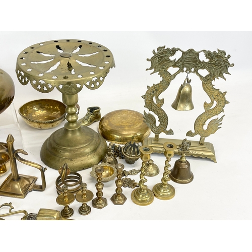 697 - A quantity of brassware. Including a Victorian trivet stand, a Victorian kettle, a Chinese brass gon... 