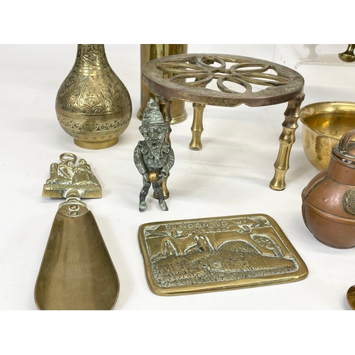 697 - A quantity of brassware. Including a Victorian trivet stand, a Victorian kettle, a Chinese brass gon... 