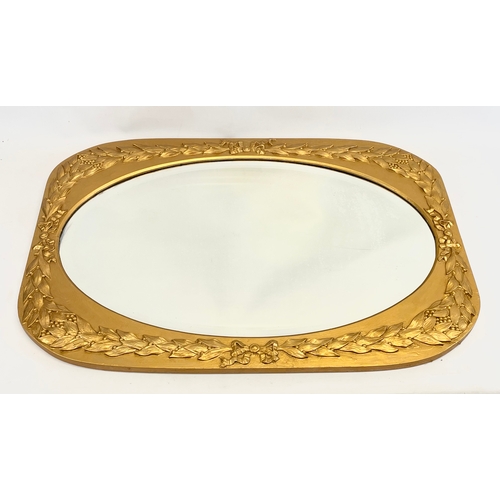 191 - An early 20th century ornate gilt wood framed mirror. 87.5 x 62cm