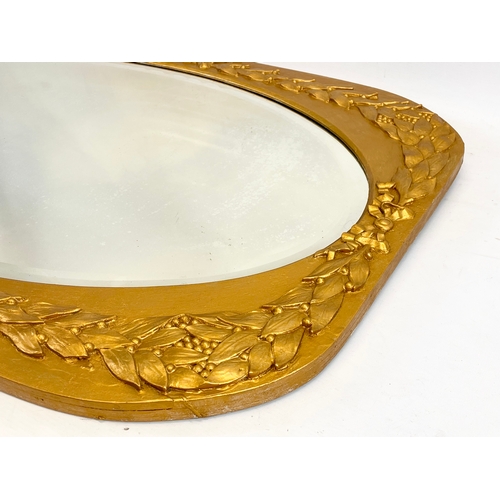 191 - An early 20th century ornate gilt wood framed mirror. 87.5 x 62cm