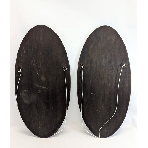 203 - A pair of large wooden wall plaques. 34.5x77cm