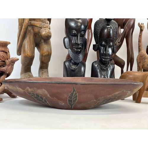 211 - A collection of large African wooden ornaments. Sierra Leone. Largest 74cm