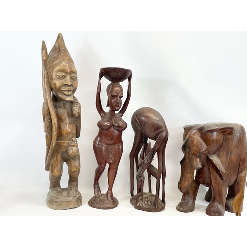 211 - A collection of large African wooden ornaments. Sierra Leone. Largest 74cm