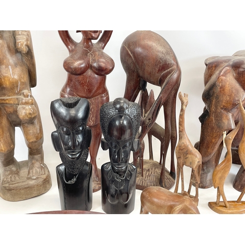 211 - A collection of large African wooden ornaments. Sierra Leone. Largest 74cm