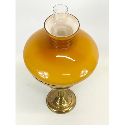 205 - A vintage brass double burner oil lamp with glass shade. 23 x 54cm