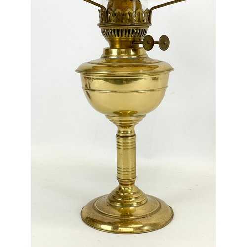 205 - A vintage brass double burner oil lamp with glass shade. 23 x 54cm