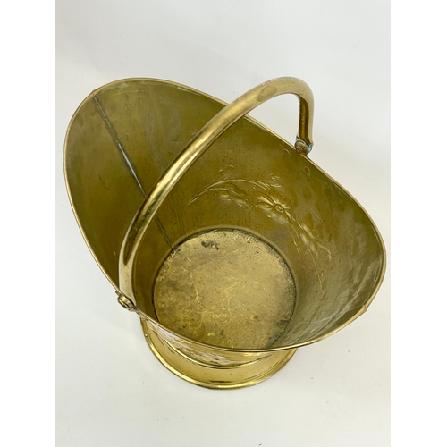 207 - A vintage brass coal bucket and a large Victorian style copper jug. Bucket measures 38.5 x 29 x 34cm