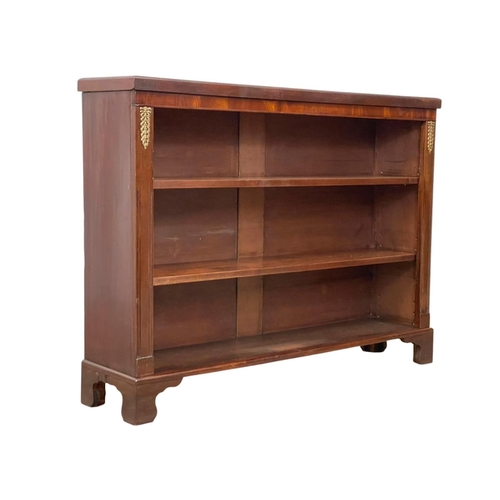 998 - A 19th century mahogany open bookcase with brass mounts and on bracket feet. 126 x 29 x 95cm