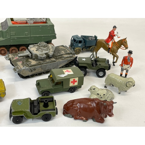 276 - A quantity of model tanks, trucks and animals etc. Dinky, Britains, Corgi.