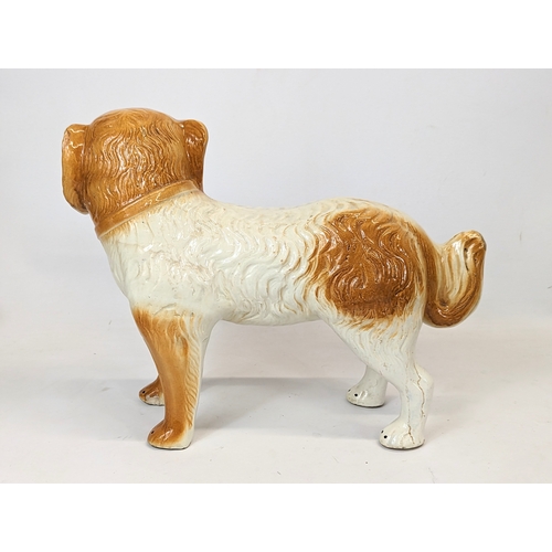 642 - A large Victorian Staffordshire pottery dog. 36x28cm