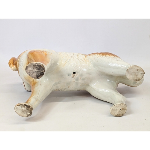 642 - A large Victorian Staffordshire pottery dog. 36x28cm