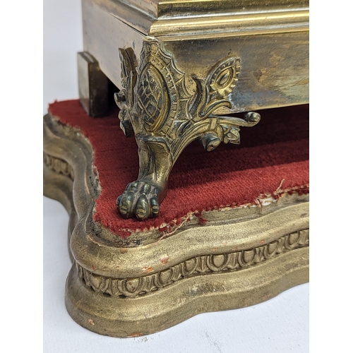 194 - A large pair of mid 19th century gilded brass garnitures on wooden stands, in the Neoclassical style... 