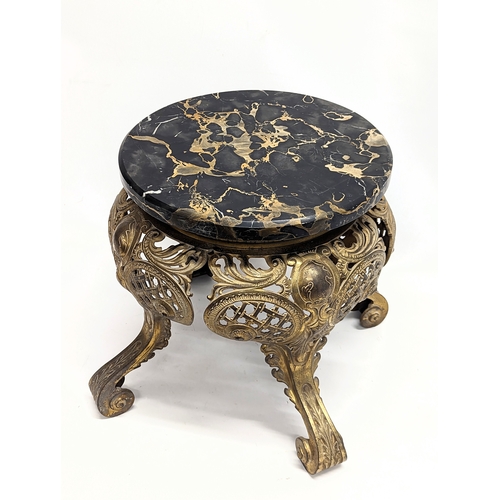 893 - A heavy ornate brass plant stand with a marble top. 39.5x39cm