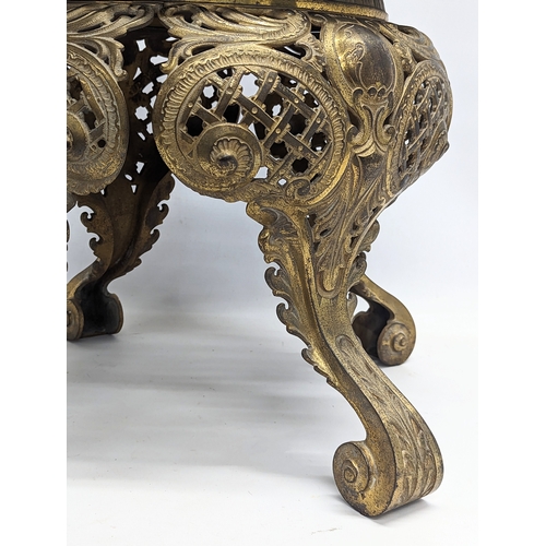 893 - A heavy ornate brass plant stand with a marble top. 39.5x39cm