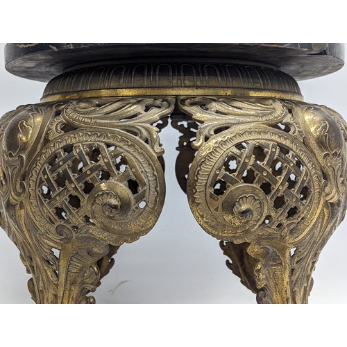 893 - A heavy ornate brass plant stand with a marble top. 39.5x39cm