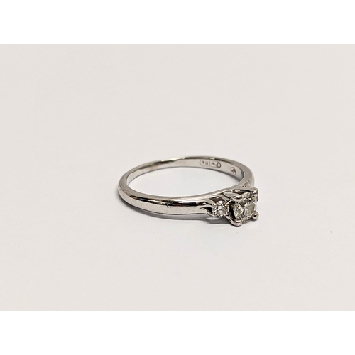 609 - An 18ct white gold, diamond 3 stone. Estimate 0.25ct centre + 0.10ct.