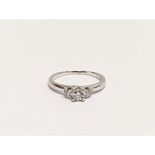 609 - An 18ct white gold, diamond 3 stone. Estimate 0.25ct centre + 0.10ct.