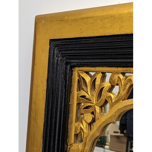 294 - An ornate gilt framed mirror. 61.5x32cm