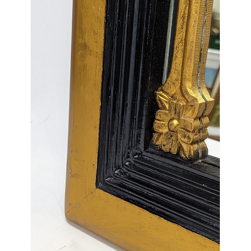 294 - An ornate gilt framed mirror. 61.5x32cm