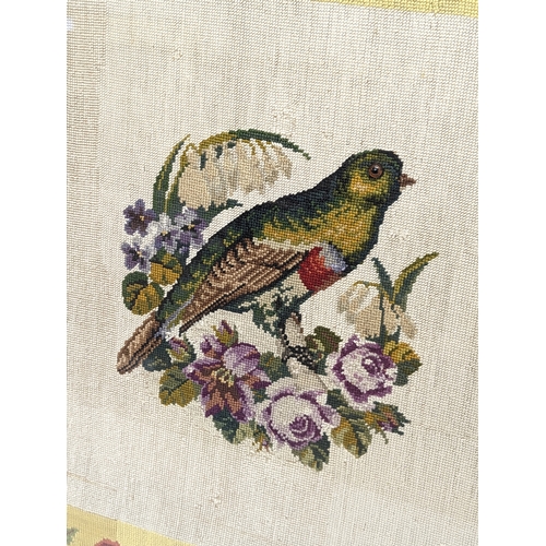 336 - An early 20th century wool worked tapestry of bird with glass eye. 64x64cm