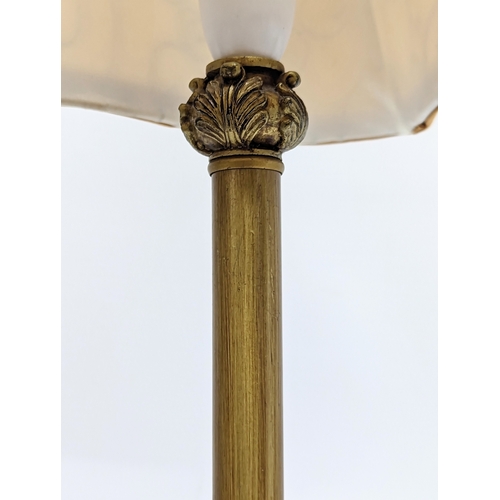 299 - A pair of tall gilt table lamps. 65cm including shade.