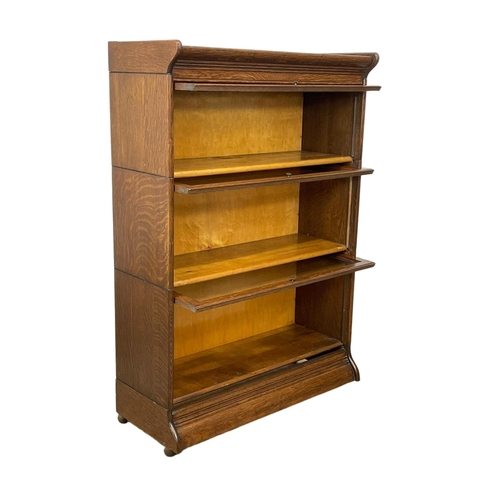 782 - An early 20th century oak stacking bookcase by Gunn. Circa 1900-20. 87 x 36 x 127cm