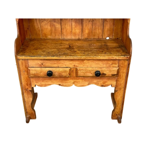 797 - A late Georgian Irish pine settle dresser. Circa 1830-1840.