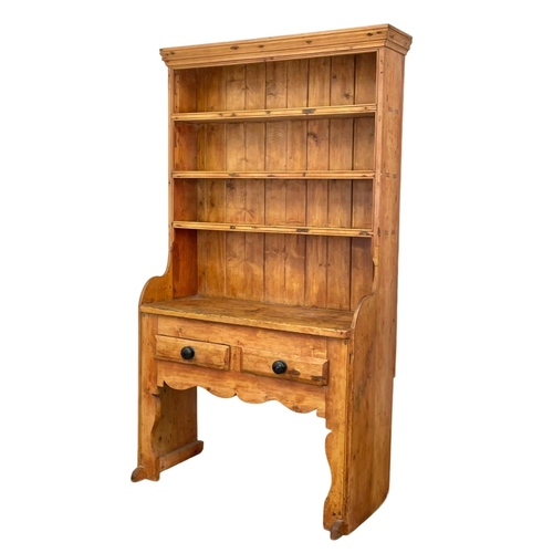 797 - A late Georgian Irish pine settle dresser. Circa 1830-1840.