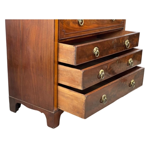 805 - A George IV inlaid mahogany secretaire chest of drawers, with brass drop ring handles and on bracket... 