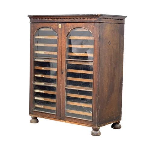 843 - A Victorian pine collectors cabinet, with 2 glazed doors and original scumble paint. 88 x 45 x 108cm