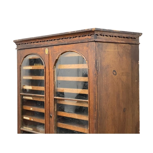 843 - A Victorian pine collectors cabinet, with 2 glazed doors and original scumble paint. 88 x 45 x 108cm