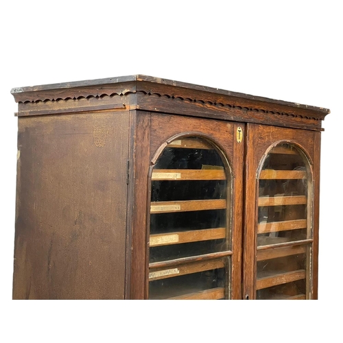 843 - A Victorian pine collectors cabinet, with 2 glazed doors and original scumble paint. 88 x 45 x 108cm