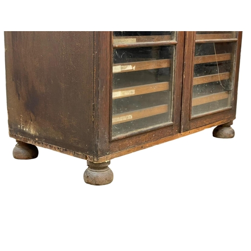 843 - A Victorian pine collectors cabinet, with 2 glazed doors and original scumble paint. 88 x 45 x 108cm