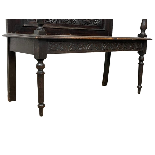 846 - A Victorian carved oak hall bench. Circa 1890. 107 x 43 x 96cm