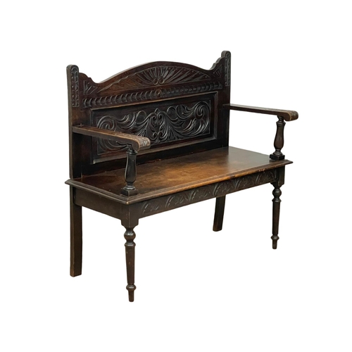 846 - A Victorian carved oak hall bench. Circa 1890. 107 x 43 x 96cm