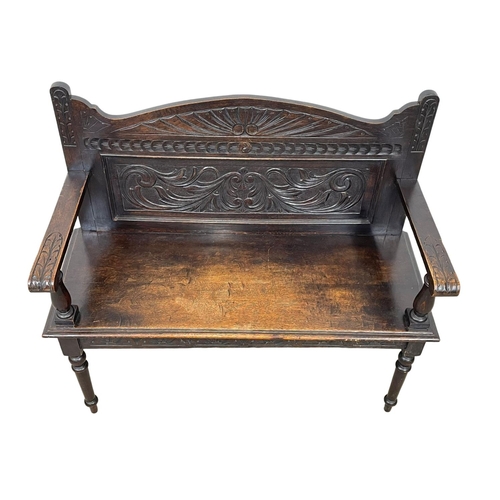 846 - A Victorian carved oak hall bench. Circa 1890. 107 x 43 x 96cm