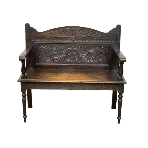 846 - A Victorian carved oak hall bench. Circa 1890. 107 x 43 x 96cm