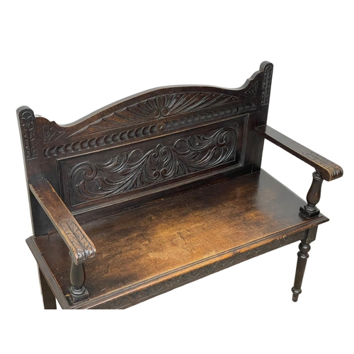 846 - A Victorian carved oak hall bench. Circa 1890. 107 x 43 x 96cm