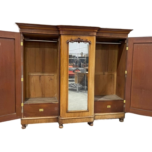 869 - A very large Victorian mahogany triple door wardrobe. With interior drawers.  250 x 75 x 215cm