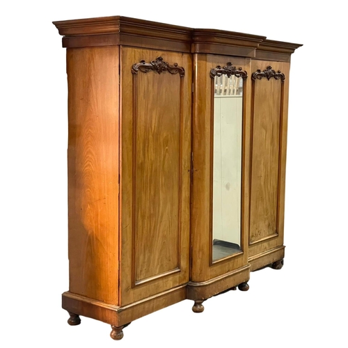 869 - A very large Victorian mahogany triple door wardrobe. With interior drawers.  250 x 75 x 215cm